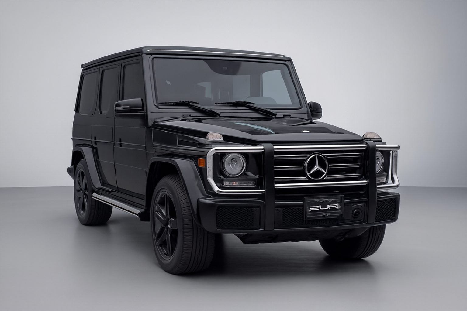 Same G-Class on a gray studio background