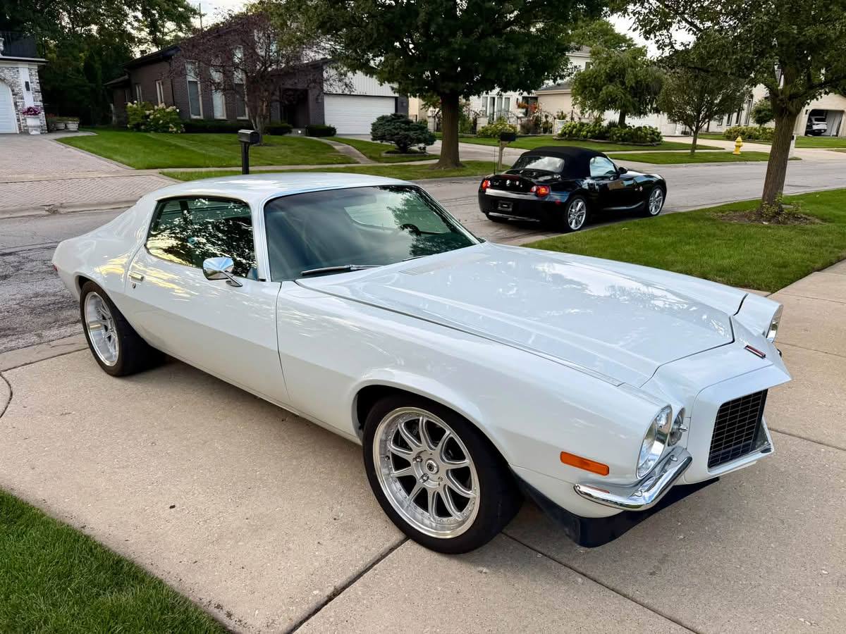 White Camaro parked on a suburban driveway